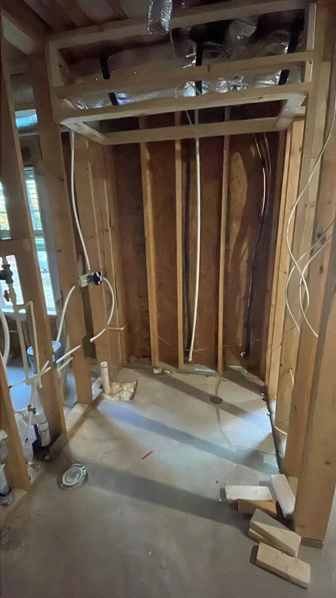 Unfinished basement bathroom area before renovation