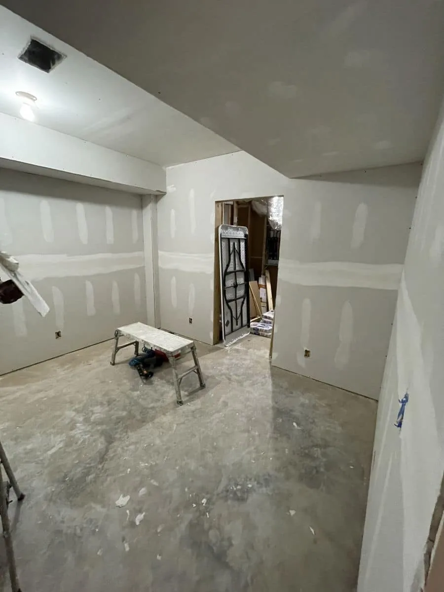 Basement drywall installation enclosing the walls and ceiling