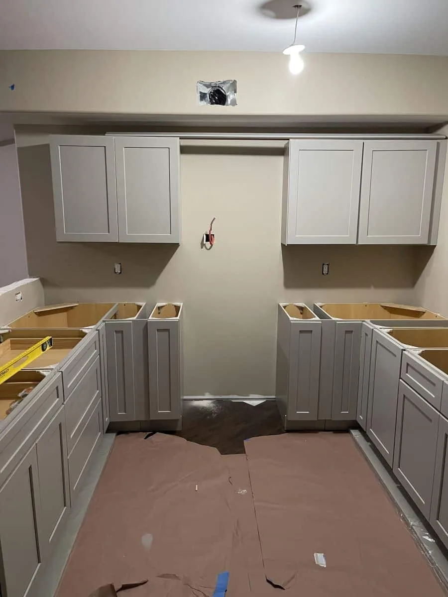 Basement kitchenette shaker cabinet installation in progress