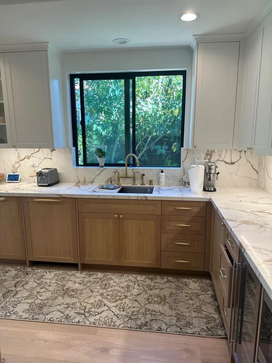Kitchen sink wall after renovation with brighter finishes